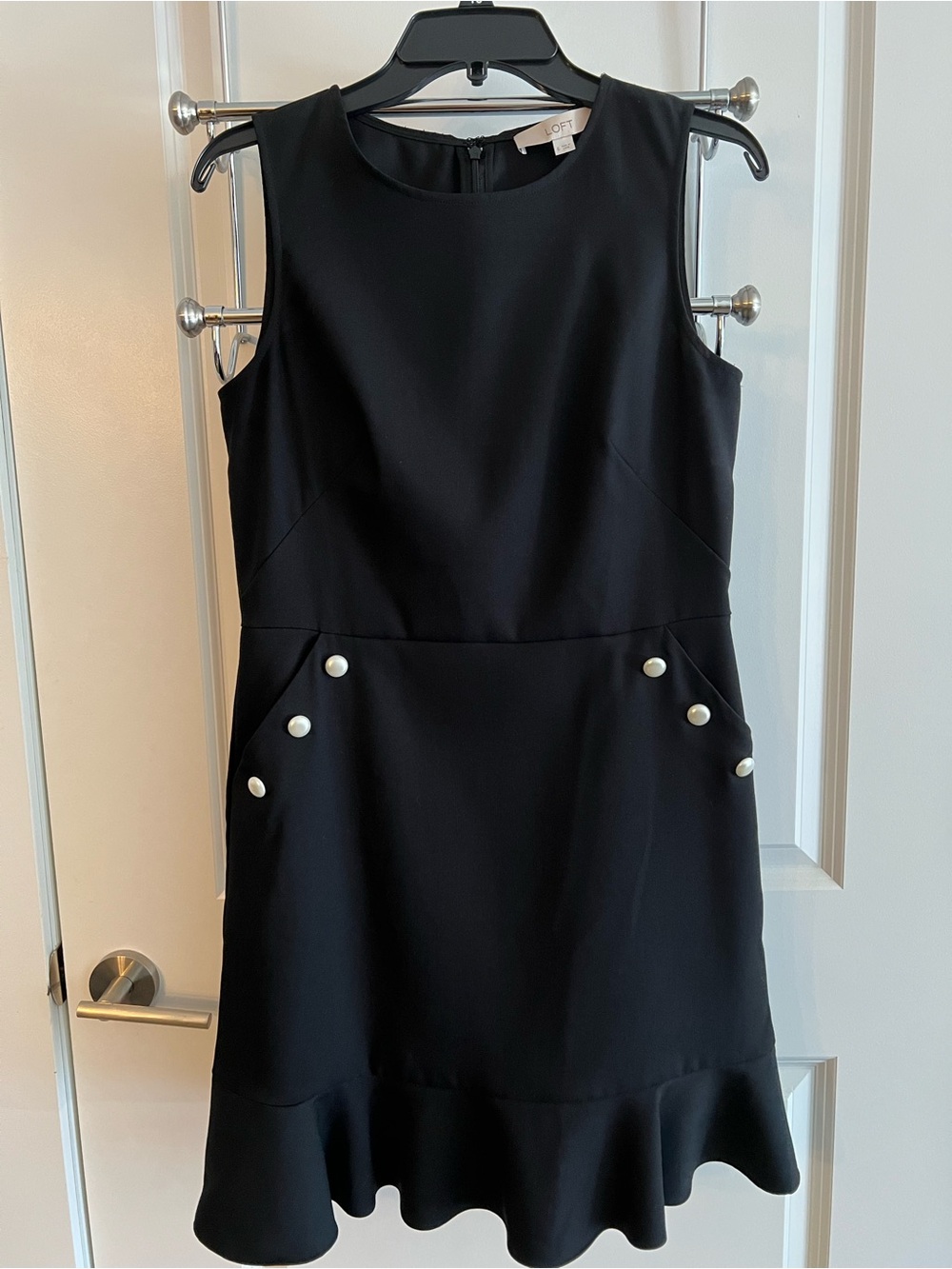 Loft Black Sleeveless Ruffle-Hem Dress with Pearl Buttons on pockets.